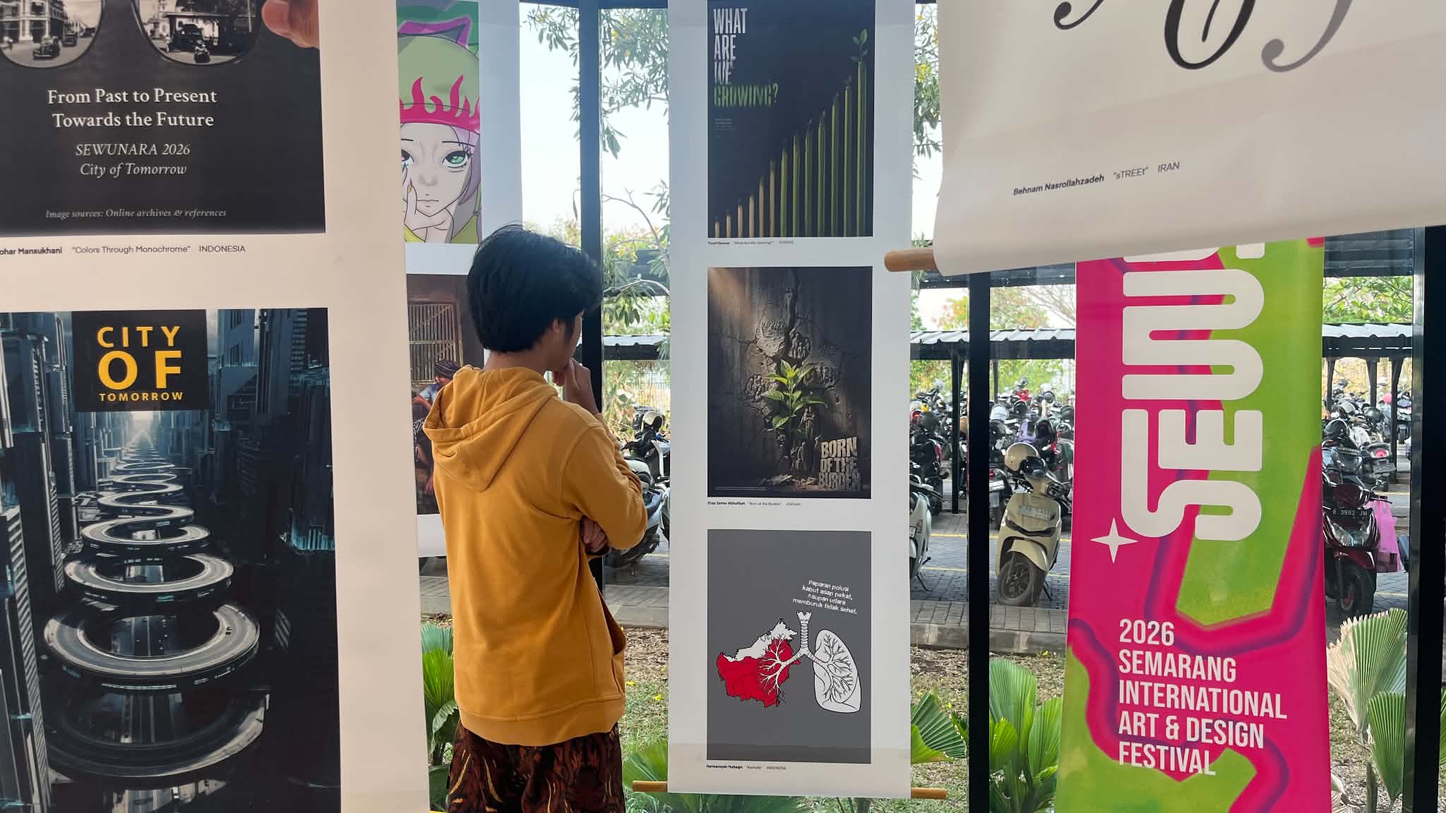 Visitor viewing the SEWUNARA 2026 poster exhibition